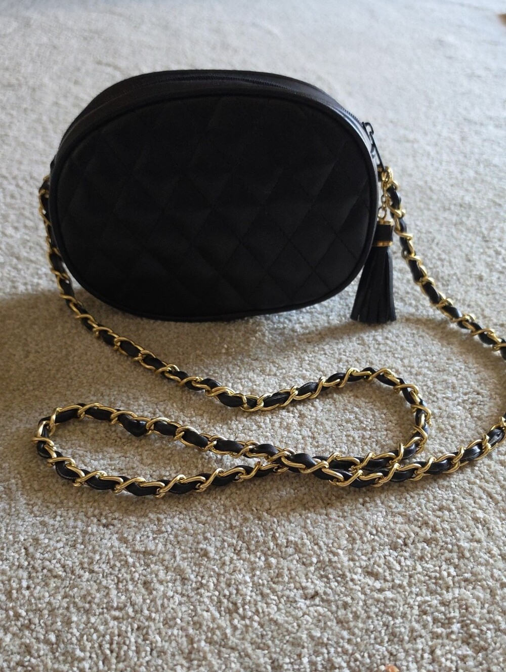 Black Quilted Oval Crossbody Bag with Gold Chain
